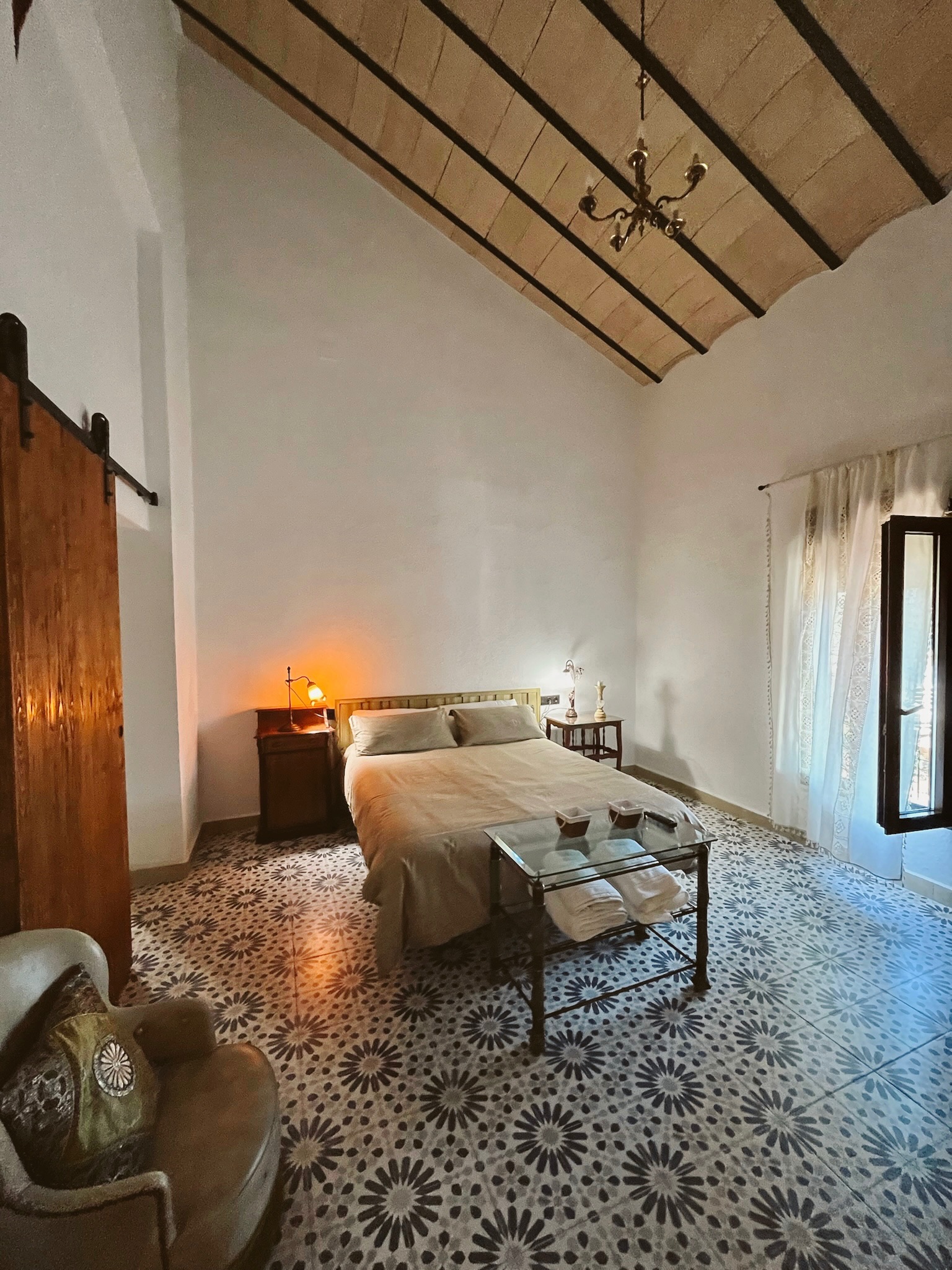 Dormitorio con ventana y techo de vigas de La Antigua Estación